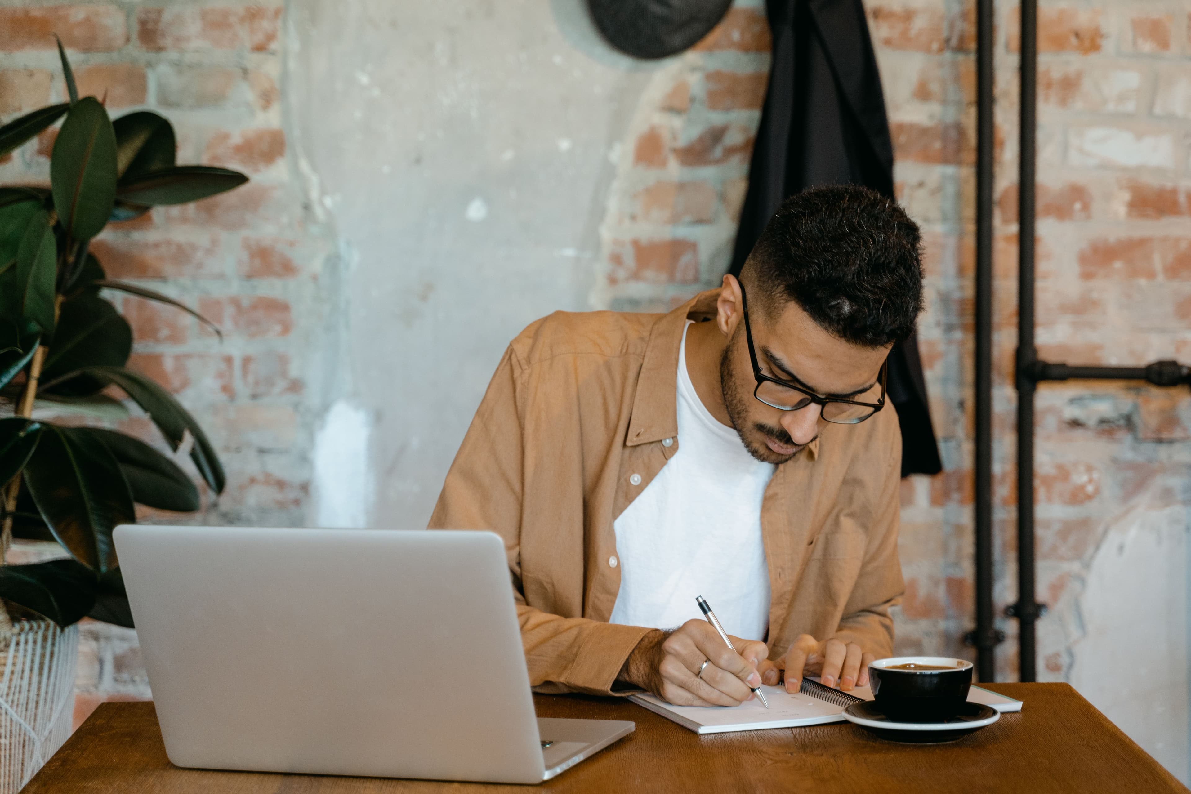 Person writing thoughtfully in a notebook