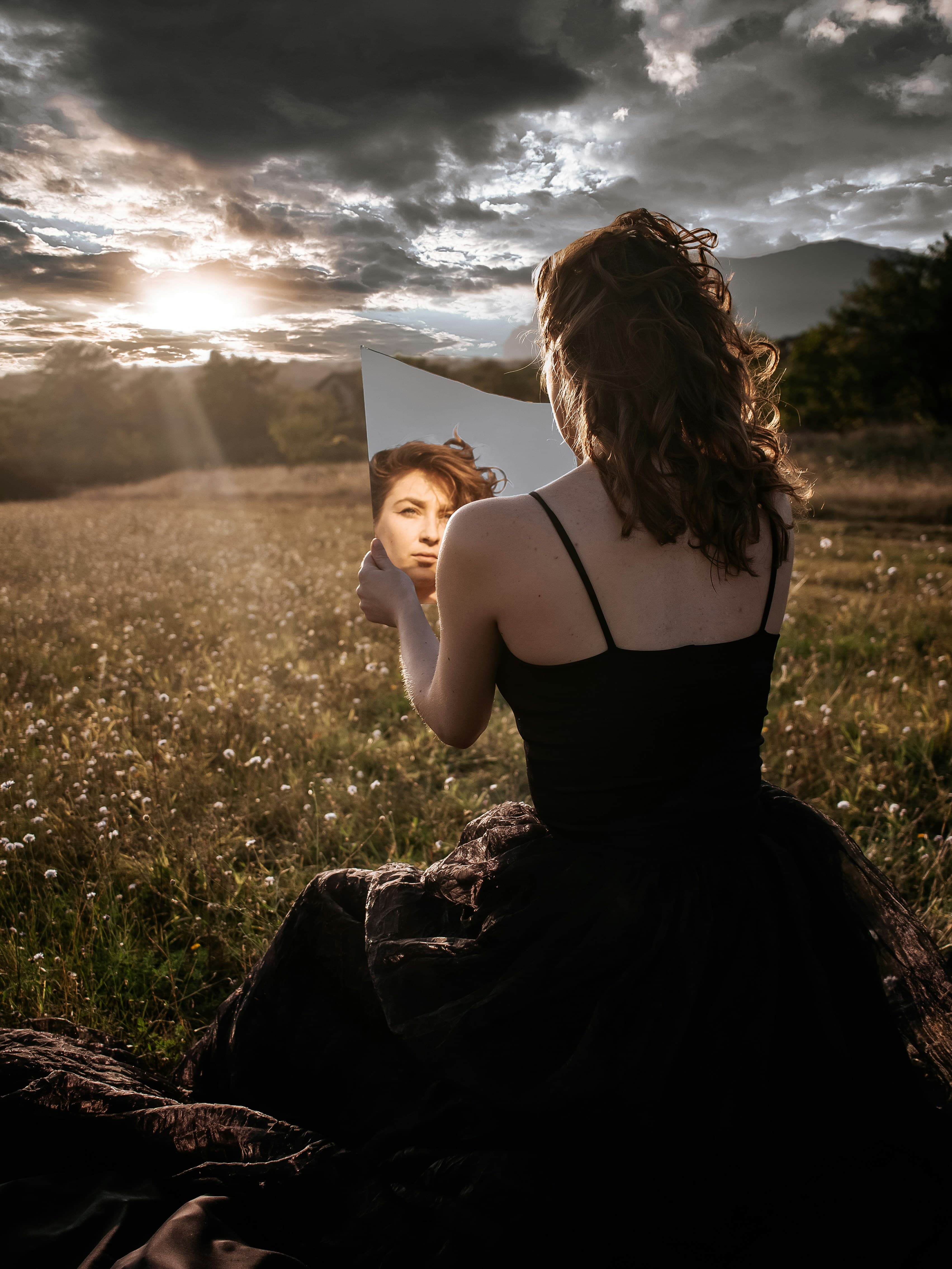 Person calmly looking at their reflection in a mirror